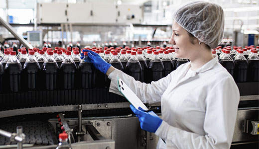 Plant worker inspecting beverages