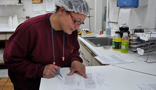 Worker writing with pen