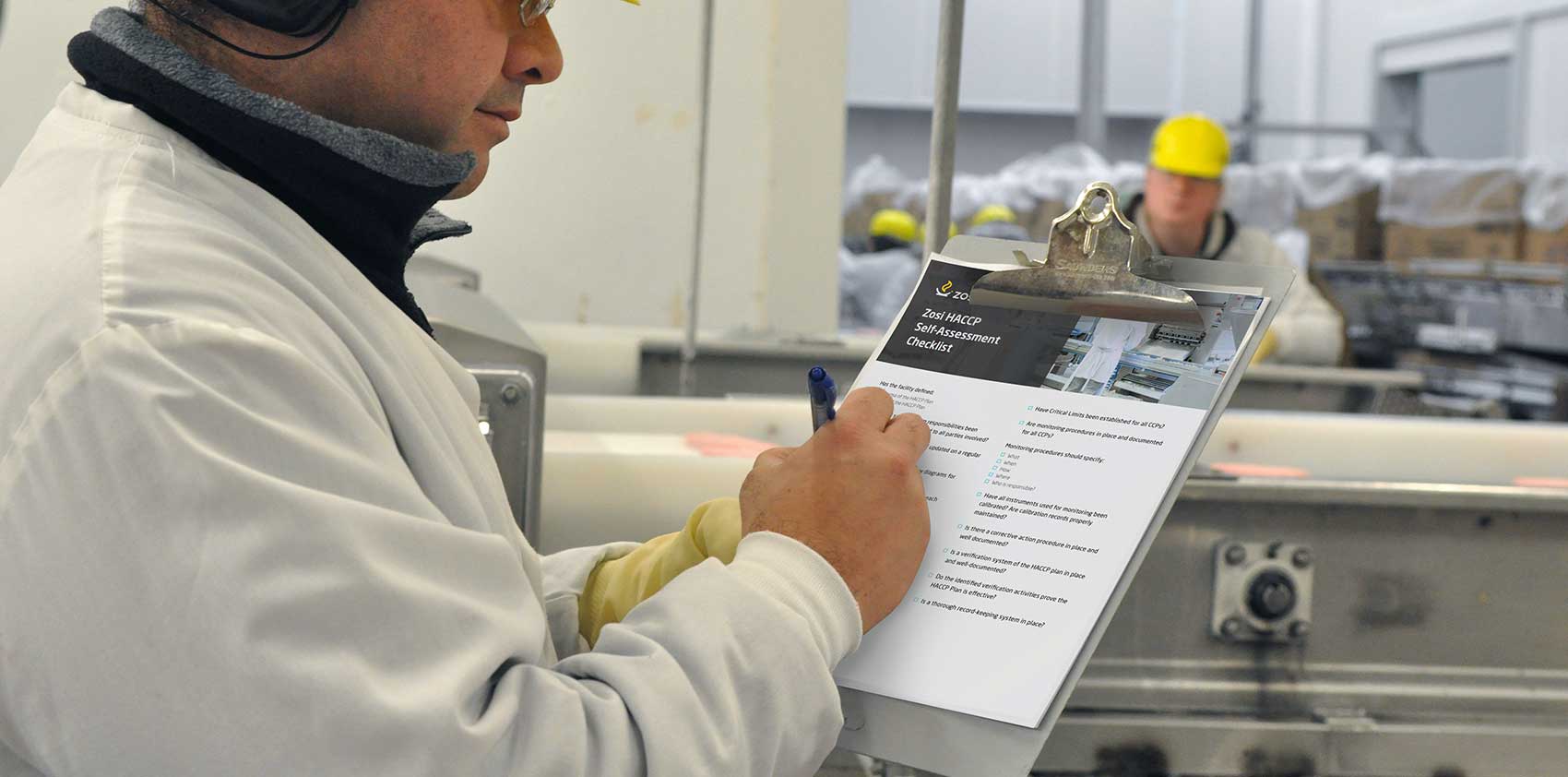 Worker writing on a clipboard